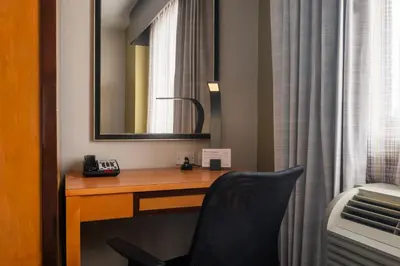 a desk with a telephone and a mirror in a hotel room at Holiday Inn Express - Times Square by IHG in New York