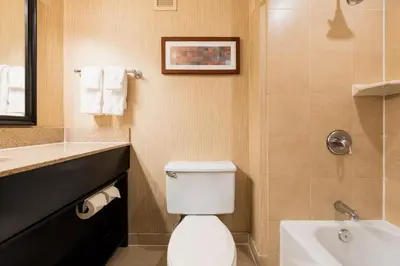 a bathroom with a toilet and a sink at Crowne Plaza Newark Airport by IHG in Elizabeth