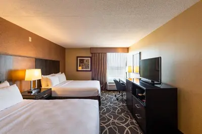 a hotel room with two beds and a flat screen tv at Crowne Plaza Newark Airport by IHG in Elizabeth
