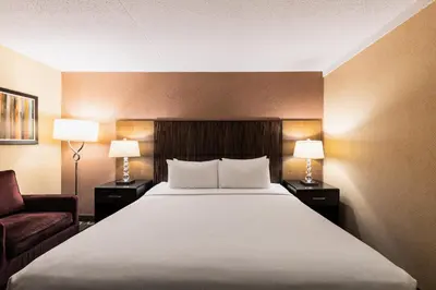 a hotel room with a large bed and two lamps at Crowne Plaza Newark Airport by IHG in Elizabeth