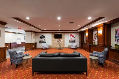 a lobby with a black couch and chairs at Crowne Plaza Newark Airport by IHG in Elizabeth