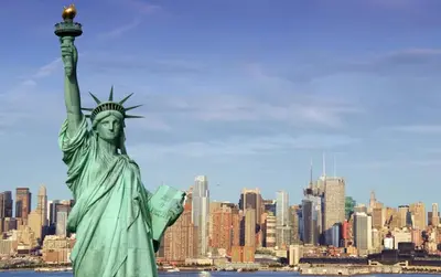 a statue of liberty with a city in the background at Candlewood Suites Secaucus by IHG in Secaucus