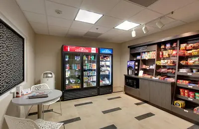 a grocery store with a table and a drink cooler at Candlewood Suites Secaucus by IHG in Secaucus