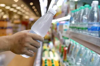 a person holding a plastic bottle in a store aisle at DoubleTree by Hilton Hotel Wilmington in Wilmington