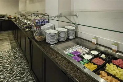 a buffet line in a restaurant with plates and food at DoubleTree by Hilton Hotel Wilmington in Wilmington