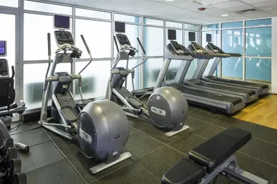 a gym with rows of treadmills and elliptical machines at DoubleTree by Hilton Hotel Wilmington in Wilmington