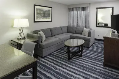 a living room with a couch and a table at DoubleTree by Hilton Hotel Wilmington in Wilmington