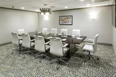 a conference room with a table and white chairs at DoubleTree by Hilton Hotel Wilmington in Wilmington