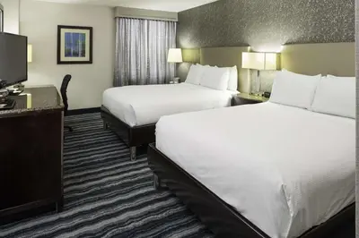 a hotel room with two beds and a flat screen tv at DoubleTree by Hilton Hotel Wilmington in Wilmington