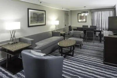 a hotel room with a couch and chairs and a living room at DoubleTree by Hilton Hotel Wilmington in Wilmington