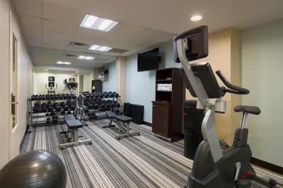 a fitness room with tread machines and a flat screen tv at Candlewood Suites NYC -Times Square by IHG in New York