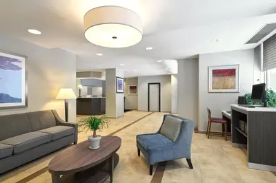 a living room with a couch and a table at Candlewood Suites NYC -Times Square by IHG in New York
