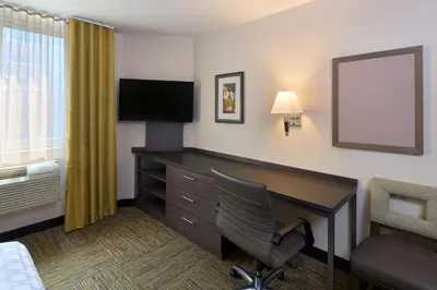 a hotel room with a desk and a chair at Candlewood Suites NYC -Times Square by IHG in New York