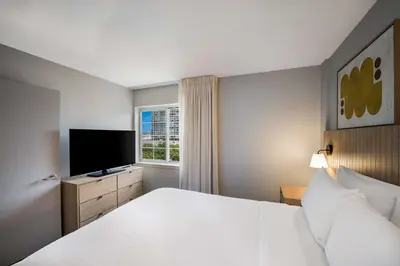 a hotel room with a bed and a television at Sonesta Simply Suites Jersey City in Jersey City