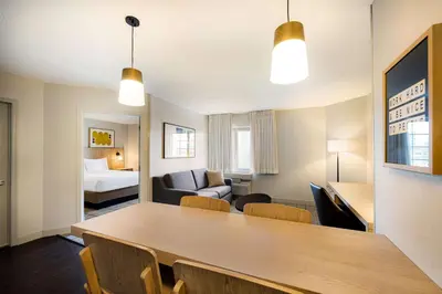 a room with a dining table and a living room at Sonesta Simply Suites Jersey City in Jersey City