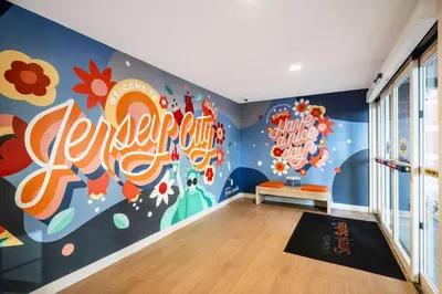 a room with a childrens mural on the wall at Sonesta Simply Suites Jersey City in Jersey City