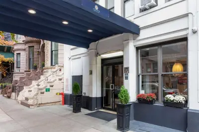 a store front with potted plants in front of it at La Quinta by Wyndham New York City Central Park in New York