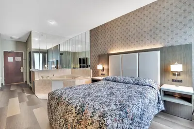 a bedroom with a large bed and a large bathroom at Horizon Inn in Avenel