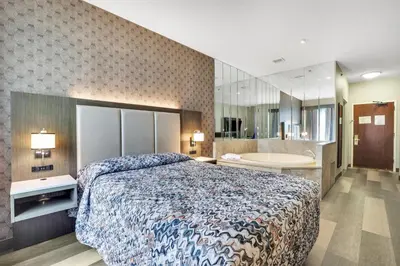 a hotel room with a bed and a bath tub at Horizon Inn in Avenel