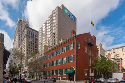 a tall red brick building with a sign on it at Holiday Inn Express Philadelphia-Midtown by IHG in Philadelphia