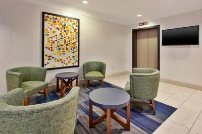 a waiting room with chairs and a table and a tv at Holiday Inn Express Philadelphia-Midtown by IHG in Philadelphia