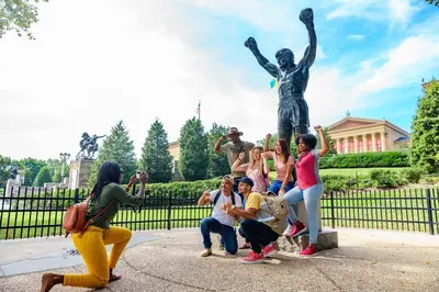 a group of people posing in front of a statue at Holiday Inn Express Philadelphia-Midtown by IHG in Philadelphia
