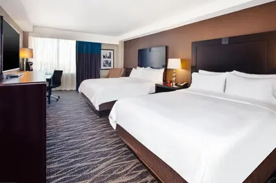 a hotel room with two beds and a desk at Holiday Inn Express Philadelphia-Midtown by IHG in Philadelphia