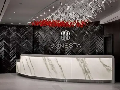 a lobby with a reception counter with a samsung sign at Sonesta Philadelphia Rittenhouse Square in Philadelphia