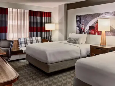 a hotel room with two beds and a chair at Sonesta Philadelphia Rittenhouse Square in Philadelphia
