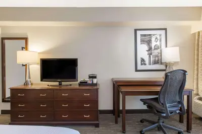a hotel room with a desk with a television and a chair at Wyndham Philadelphia-Historic District in Philadelphia