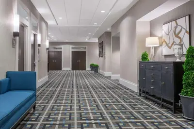 a hallway of a hospital with a blue couch at Wyndham Philadelphia-Historic District in Philadelphia