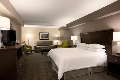 a hotel room with a large bed and a couch at Wyndham Philadelphia-Historic District in Philadelphia