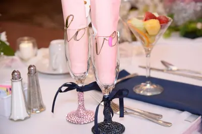 a couple of champagne glasses sitting on a table at Holiday Inn Philadelphia South-Swedesboro by IHG in Swedesboro