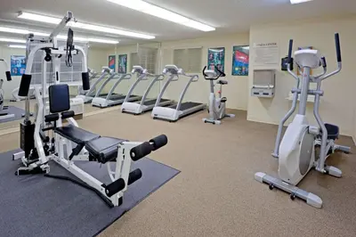 a gym with several treadmills and exercise bikes at Sonesta Simply Suites Philadelphia Mount Laurel in Mount Laurel
