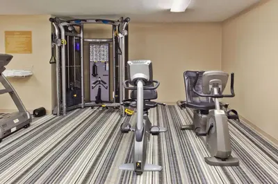 a gym with two exercise bikes and tread machines at Sonesta Simply Suites Philadelphia Mount Laurel in Mount Laurel