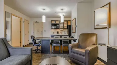 a living room and kitchen with a table and chairs at Sonesta Simply Suites Philadelphia Mount Laurel in Mount Laurel