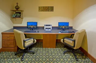 an office with two computers on a desk with two chairs at Staybridge Suites-Philadelphia/Mount Laurel by IHG in Mount Laurel