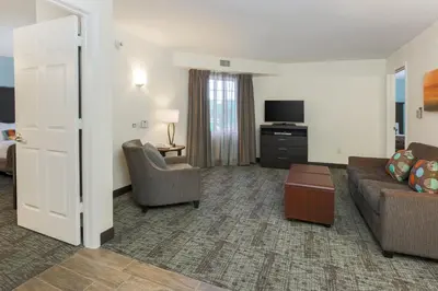 a living room with a couch and chairs and a tv at Staybridge Suites-Philadelphia/Mount Laurel by IHG in Mount Laurel
