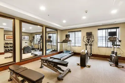 a gym with several tread machines and mirrors at Staybridge Suites-Philadelphia/Mount Laurel by IHG in Mount Laurel