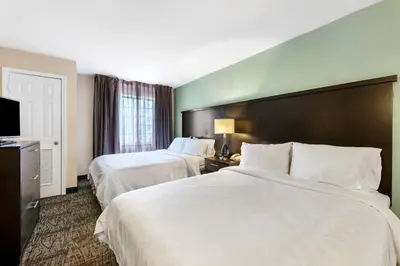 a hotel room with two beds and a television at Staybridge Suites-Philadelphia/Mount Laurel by IHG in Mount Laurel
