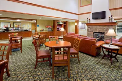 a hotel lobby with a living room with a fireplace at Staybridge Suites-Philadelphia/Mount Laurel by IHG in Mount Laurel