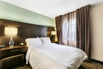 a hotel room with a large bed and a window at Staybridge Suites-Philadelphia/Mount Laurel by IHG in Mount Laurel