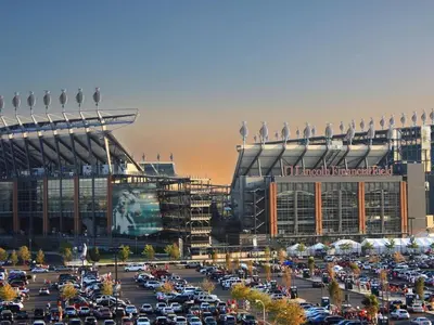 a parking lot with cars parked in front of a stadium at Holiday Inn Philadelphia-Cherry Hill by IHG in Cherry Hill