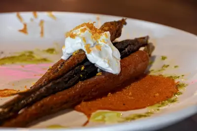 a white plate with a piece of food with whipped cream at Holiday Inn Philadelphia-Cherry Hill by IHG in Cherry Hill