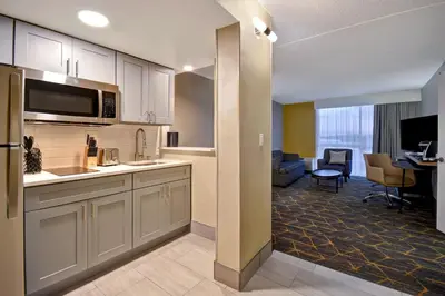 a kitchen and living room in a hotel room at Holiday Inn Philadelphia-Cherry Hill by IHG in Cherry Hill
