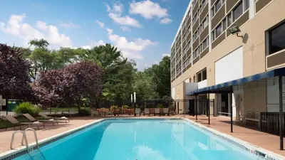 a swimming pool in front of a building at Holiday Inn Clark - Newark by IHG in Clark