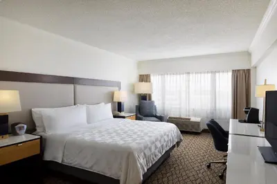 a hotel room with a large bed and a television at Holiday Inn Clark - Newark by IHG in Clark
