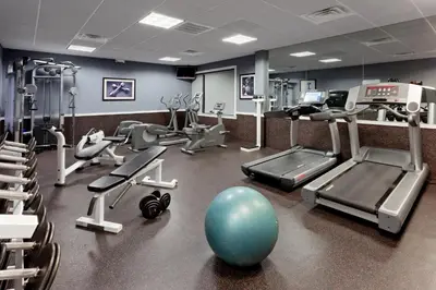a gym with exercise equipment and a blue ball on the floor at Holiday Inn Clark - Newark by IHG in Clark