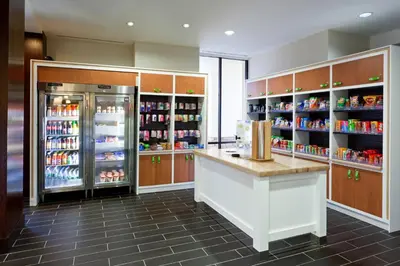 a kitchen with a refrigerator and a counter with drinks at Holiday Inn Clark - Newark by IHG in Clark
