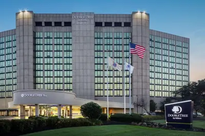 a building with two flags in front of it at DoubleTree by Hilton Cherry Hill Philadelphia in Cherry Hill